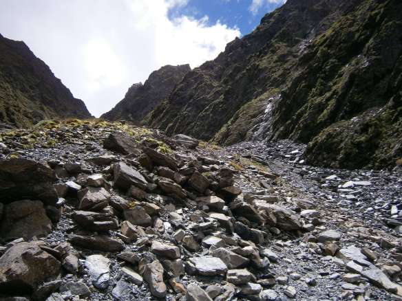 A scree slope leads to the mountain above the river.
