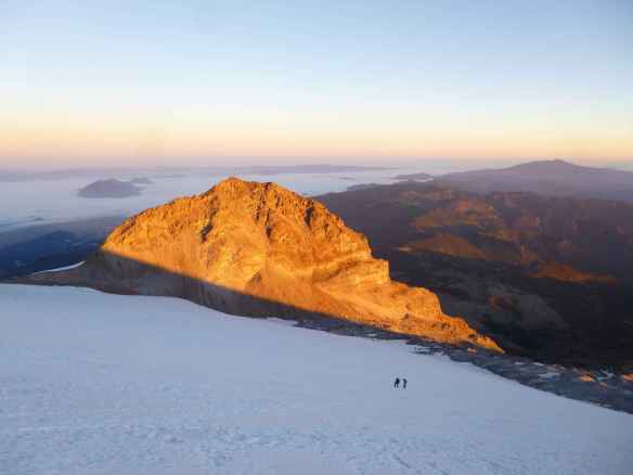 Sunrise on the 'sarcophagus' rock.  The Australian and his guide are climbing up.