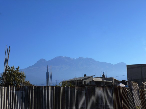 Iztaccihuatl, as viewed from the central square in Amecameca – the profile of the sleeping woman is clear in the photo: head and hair to the far left, legs and feet to the far right.