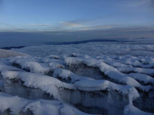 A sea of clouds below fields of penitentes.
