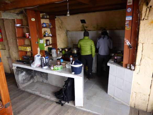 My mountain guide Pato and Fredy the refuge guardian in the cabin's kitchen.